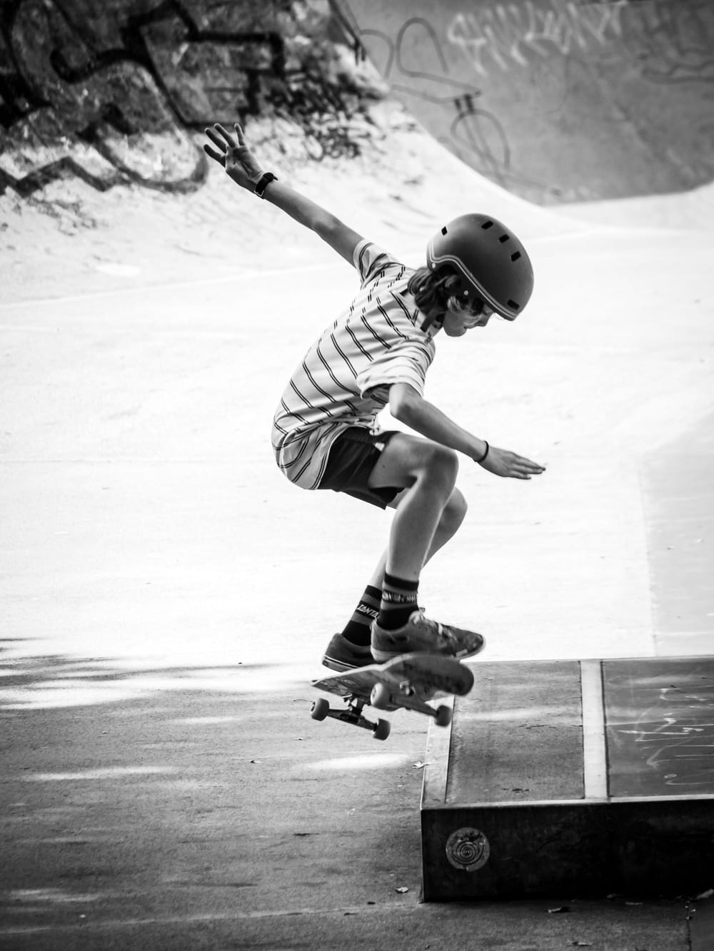 Boy on a skateboard, jump trick, skate park post image