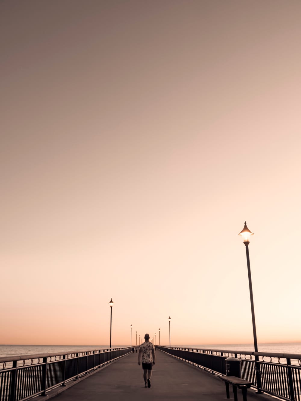 Man walking pier symmetrical creative post image