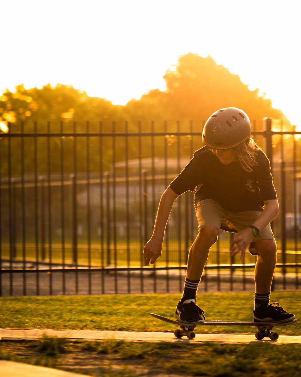 Young boy skate boarding golden hour post image