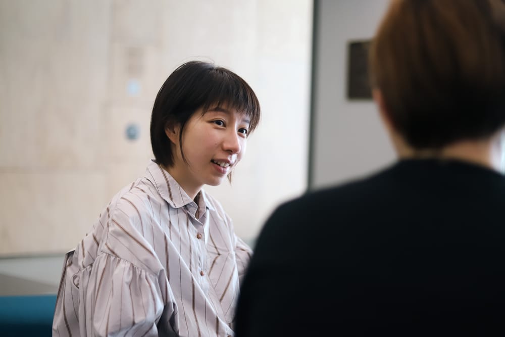 Woman smiling in conversation post image