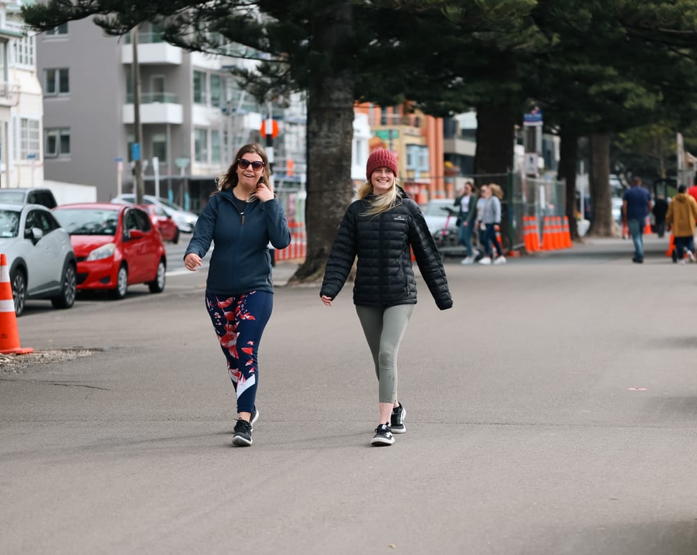 Friends walking along city street post image