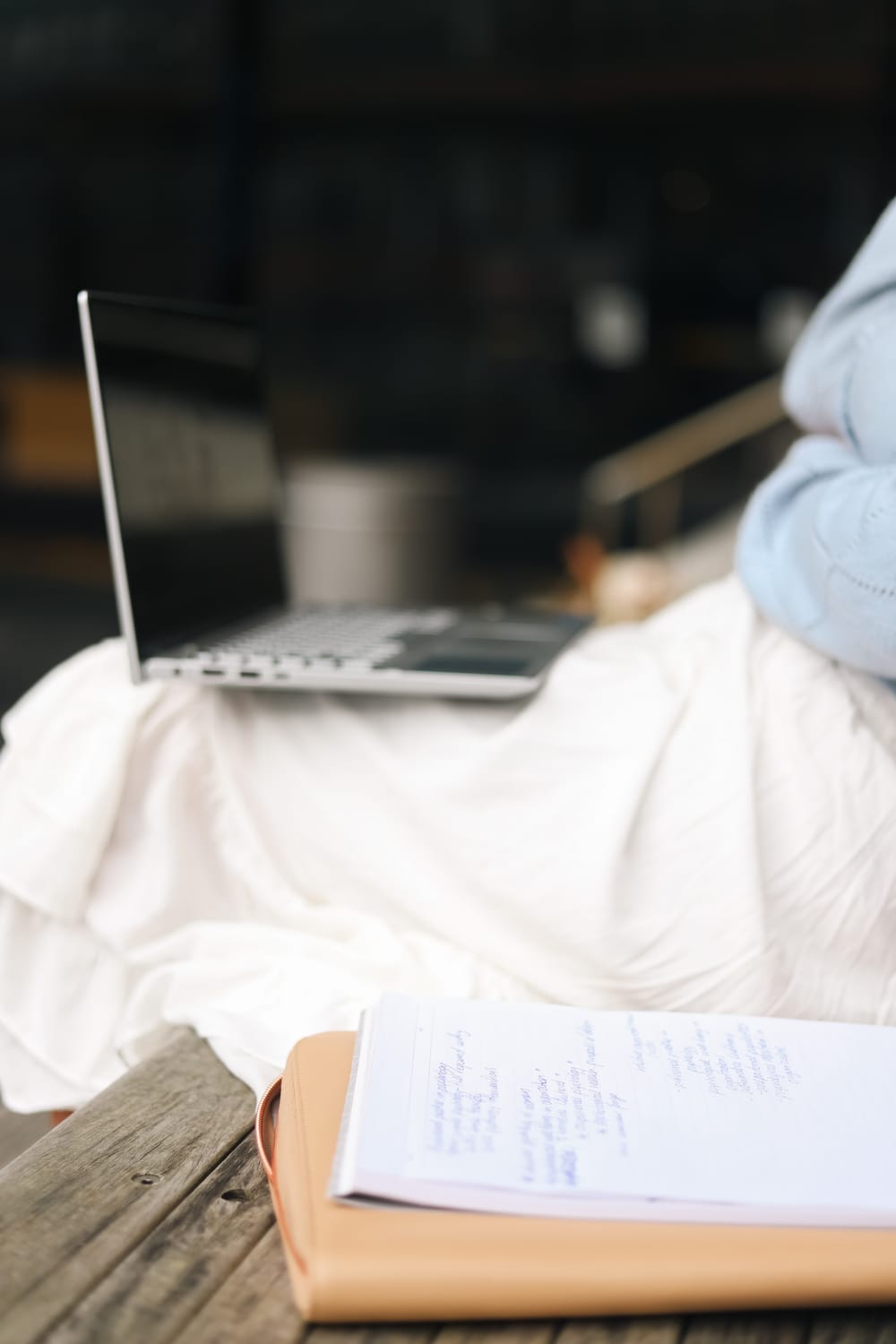 Laptop and notebook on wooden bench post image