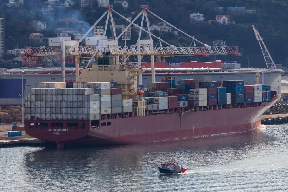 Red cargo ship in harbour post image