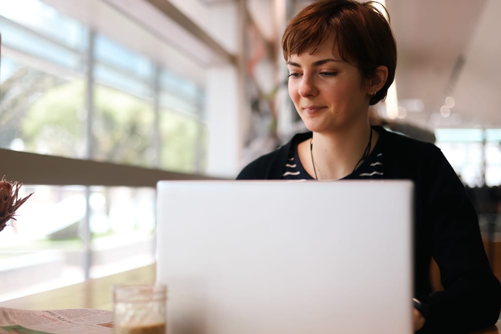 Woman with laptop in cafe post image