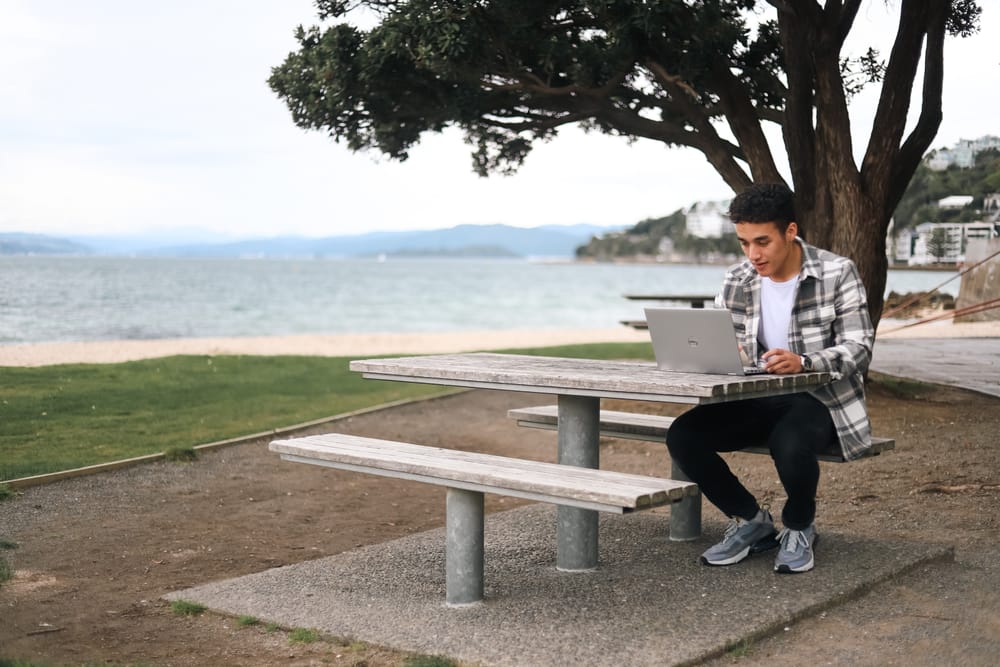 Man working outdoors at picnic table post image