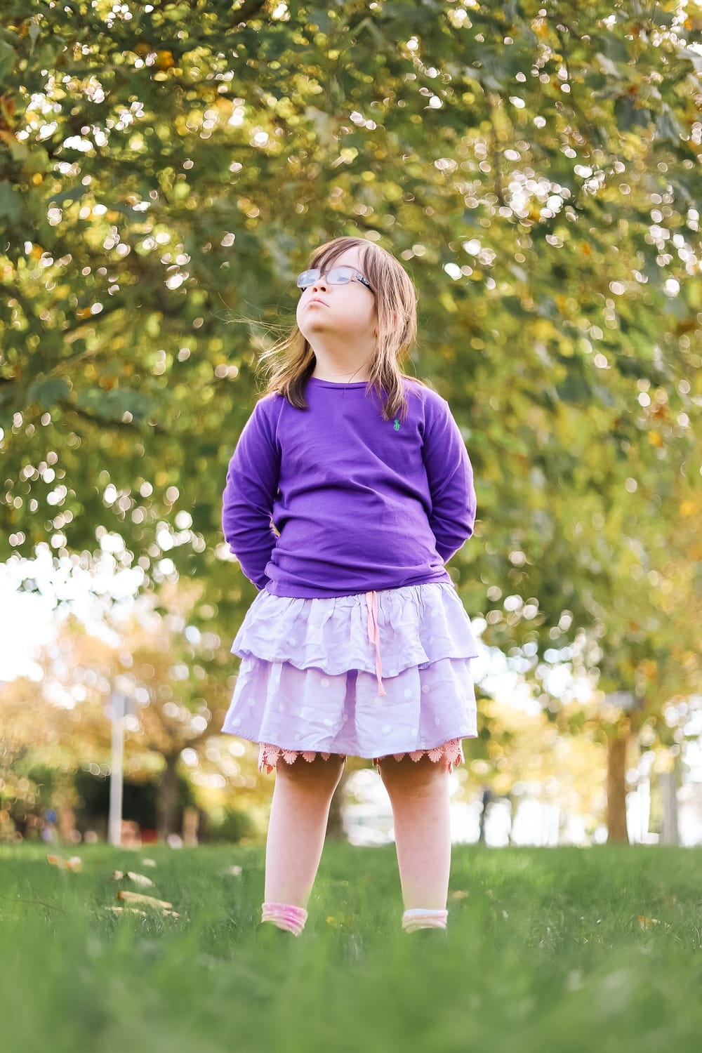 Child stands on the grass post image