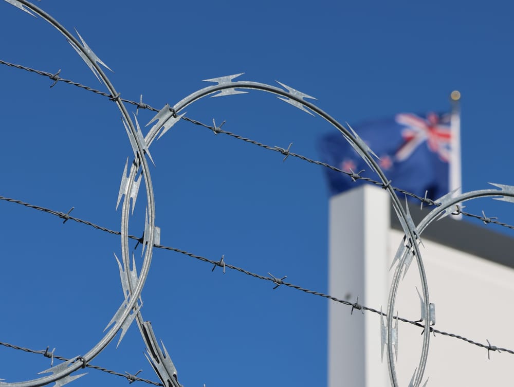 Razor wire and flag post image