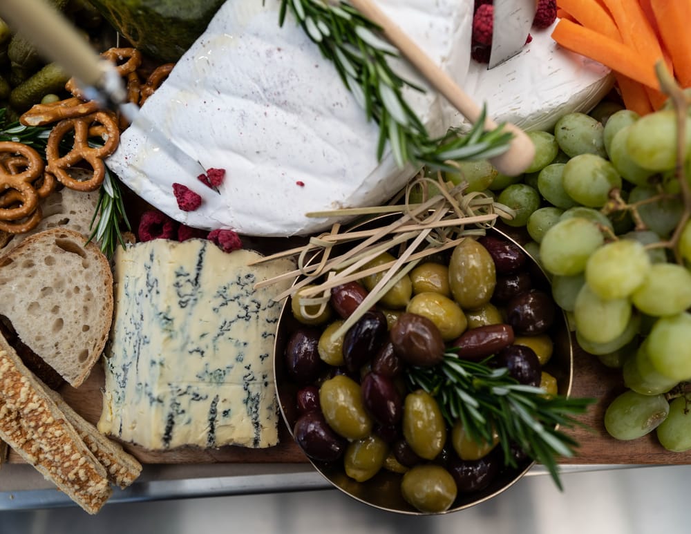 Board with cheese, olives, and fruit post image