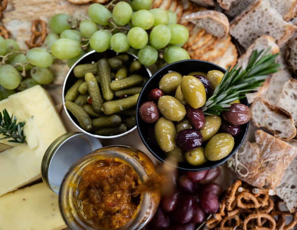 Board with grapes, olives, and chutney post image
