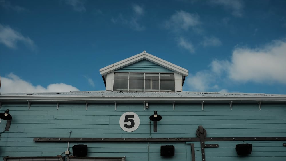 Light blue building with number 5 post image