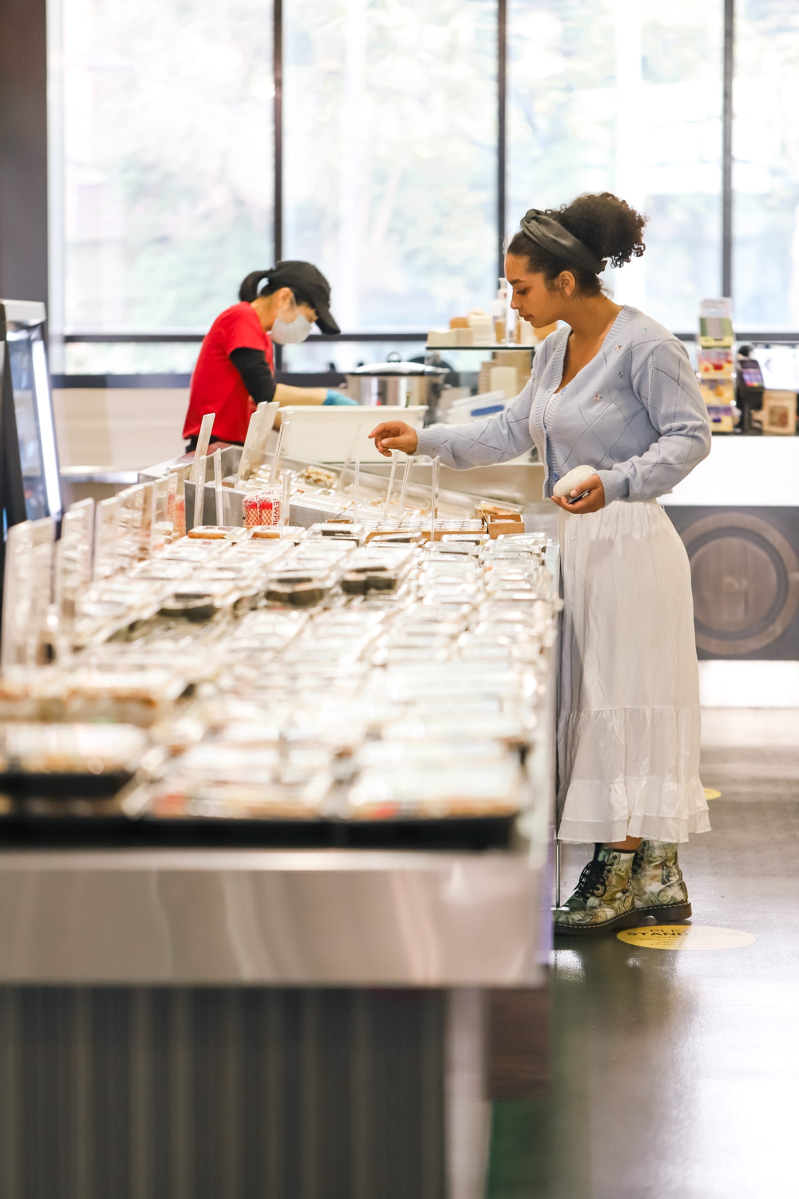 Woman selecting food at a self-service counter