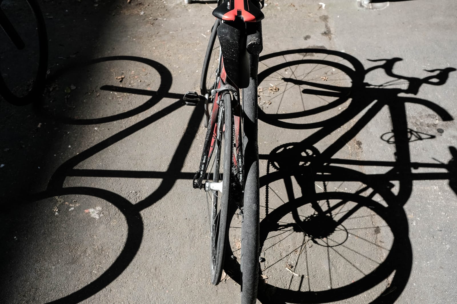 Bicycle and shadow on sunlit pavement