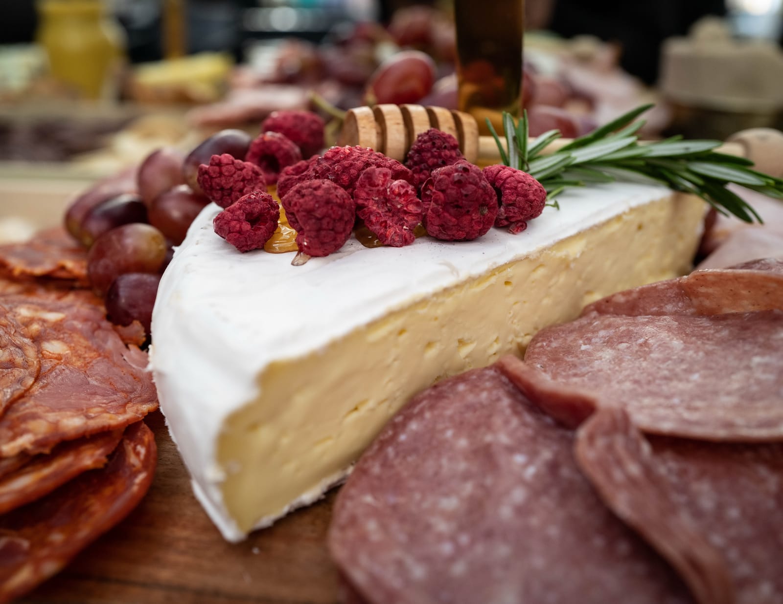 Cheese and cured meats with honey and raspberries