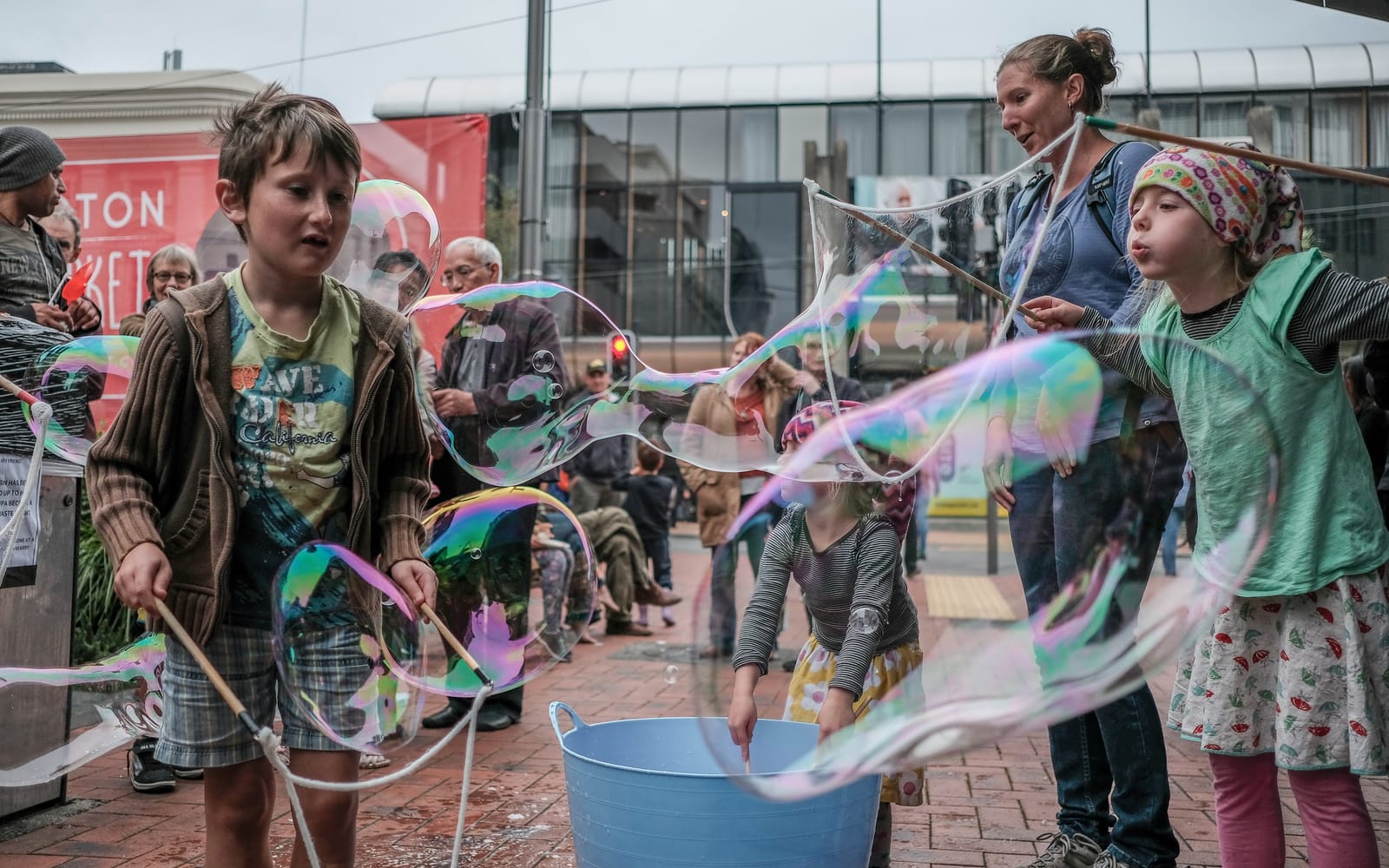 Children making bubbles at a street event