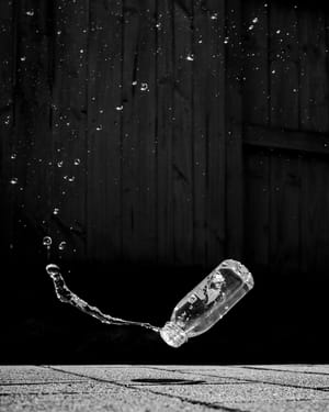 Water bottle spray droplets frozen moment post feature image