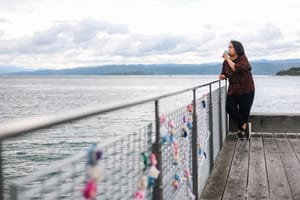 Woman enjoying coffee by the waterfront post feature image