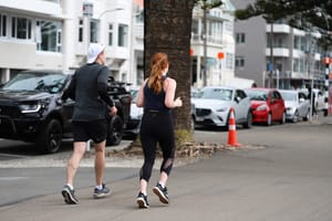 Couple jogging along city street post feature image