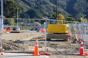 Excavator and cones at construction site post feature image