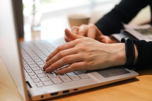 Hands typing on laptop keyboard post feature image