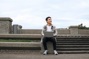 Smiling student with laptop post feature image