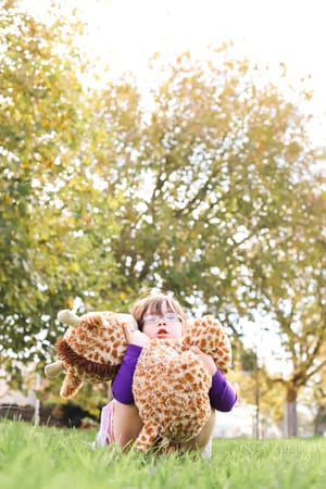 Girl hugging a toy post feature image