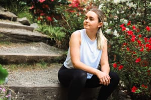 Girl sits on a stone step post feature image