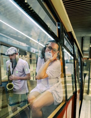 Reflection and saxophone at tram station post feature image