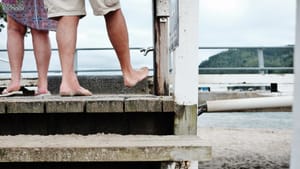 Barefoot couple on the pier post feature image