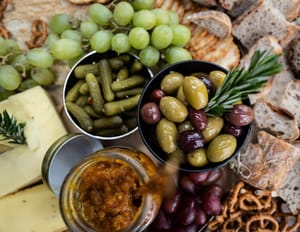 Board with grapes, olives, and chutney post feature image