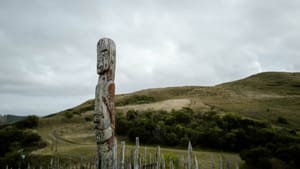 Carved pouwhenua on hillside at Ōtātara Pā post feature image