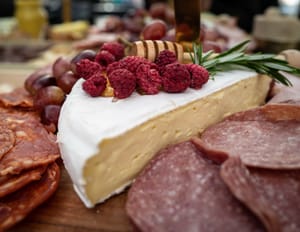 Cheese and cured meats with honey and raspberries post feature image