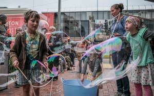 Children making bubbles at a street event post feature image