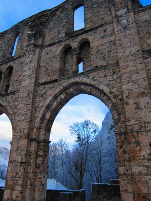 Gothic stone wall with snowy mountain backdrop post feature image