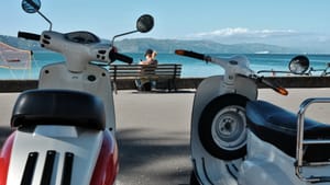 Scooters and a bench by the coastal promenade post feature image