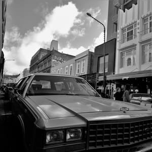 Vintage car parked on a city street post feature image